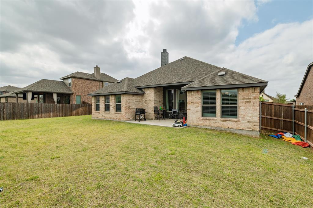 4045 Grove Valley Road Midlothian, TX 76065 - Photo 31 of 34 Rear view of property with a chimney, brick siding, a patio, a fenced backyard, and roof with shingles
