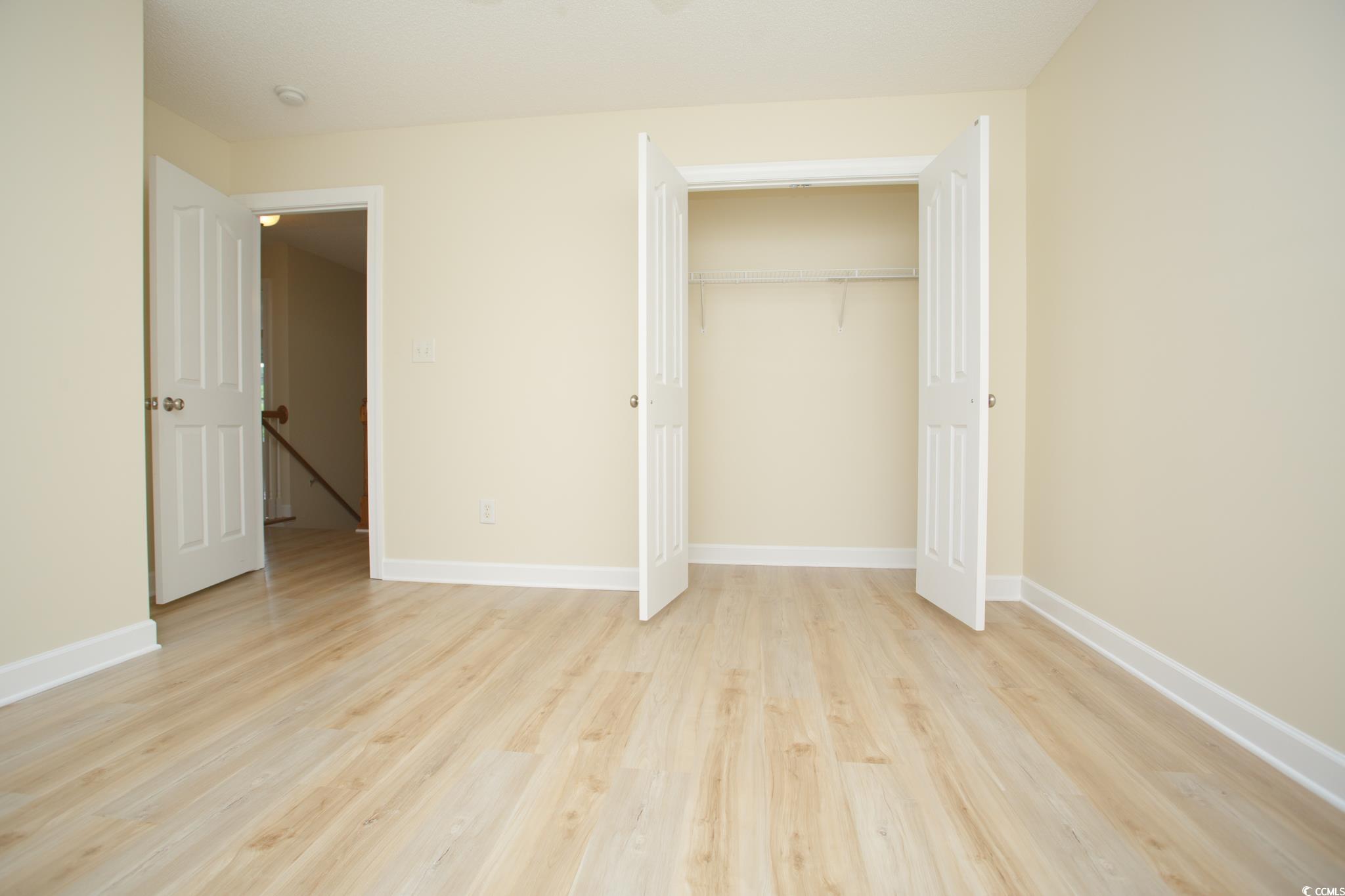 112 Molinia Drive Murrells Inlet, SC 29576 - Photo 31 of 40 Unfurnished bedroom featuring light wood-style flooring, baseboards, and a closet