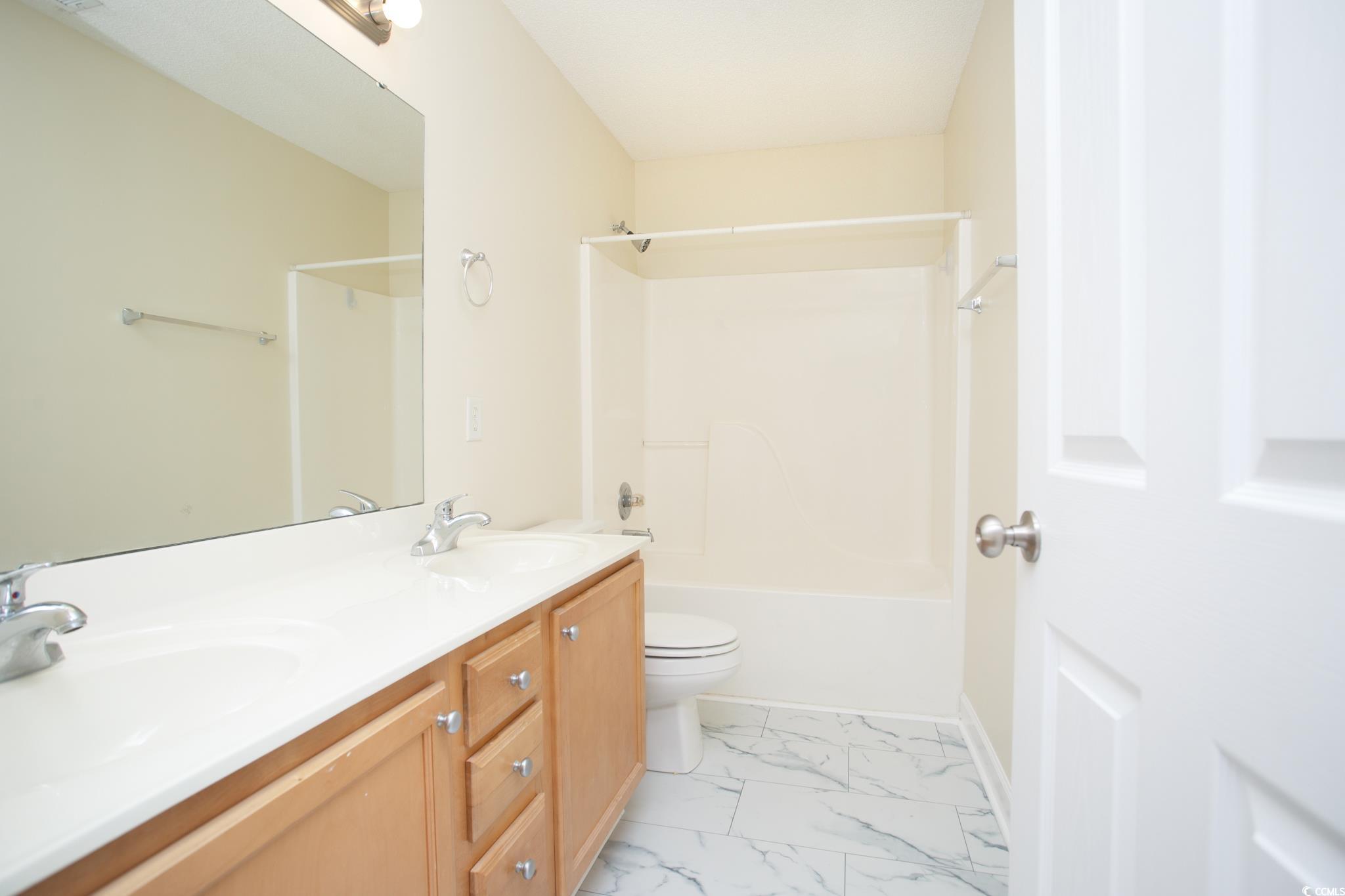 112 Molinia Drive Murrells Inlet, SC 29576 - Photo 32 of 40 Full bath featuring toilet, marble finish floors, double vanity, bathing tub / shower combination, and baseboards