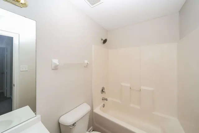 a bathroom with a toilet and a bathtub