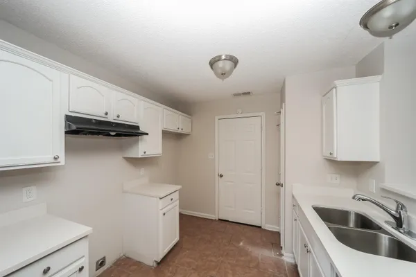 a kitchen with a sink and cabinets
