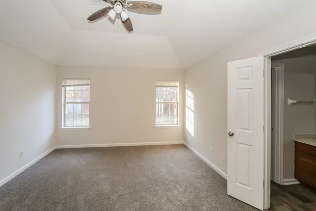 a view of room with window and ceiling fan
