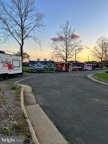 a view of street with parked cars