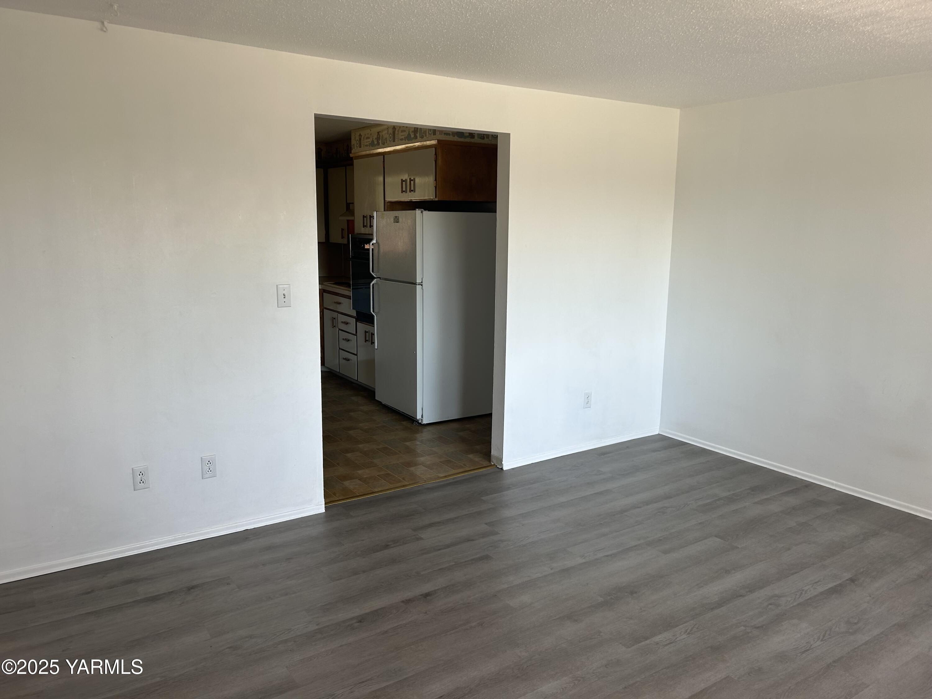 6505 Alpine Way Yakima, WA 98908 - Photo 12 of 18 a view of an empty room with wooden floor and closet