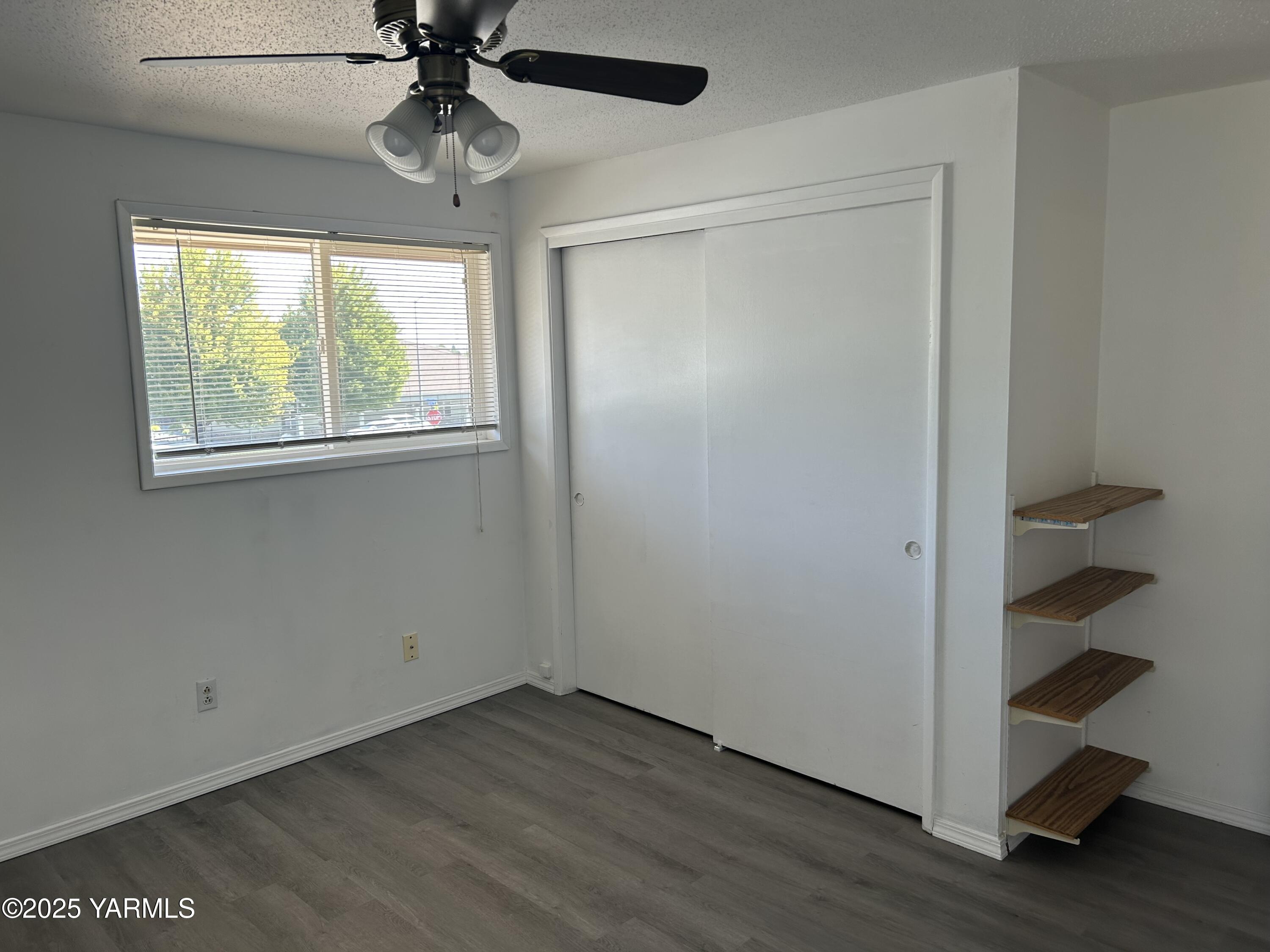 6505 Alpine Way Yakima, WA 98908 - Photo 15 of 18 a view of an empty room with a window and wooden floor