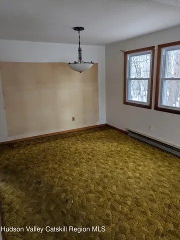 a view of an empty room with windows