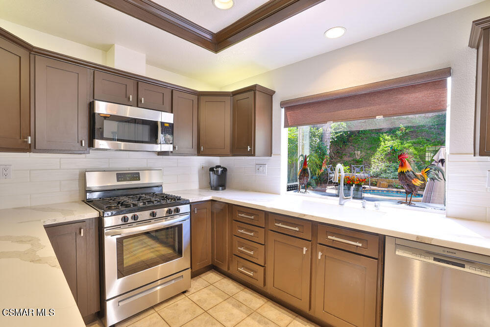 13620 Chesterfield Drive Moorpark, CA 93021 - Photo 19 of 52 a kitchen with stainless steel appliances a stove sink and microwave