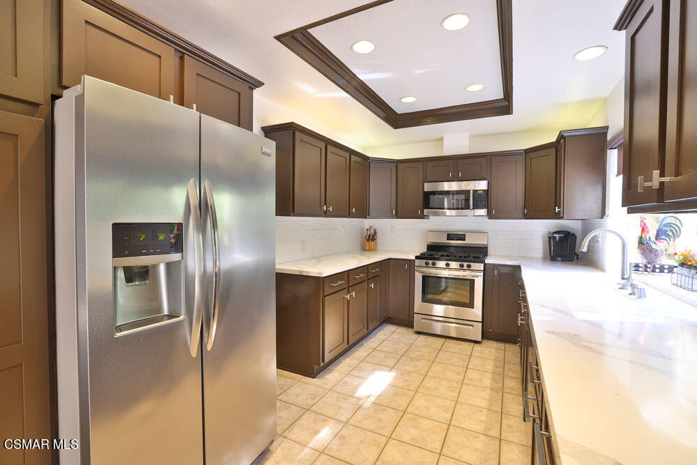 13620 Chesterfield Drive Moorpark, CA 93021 - Photo 20 of 52 a large kitchen with stainless steel appliances kitchen island granite countertop a refrigerator a sink a stove and oven