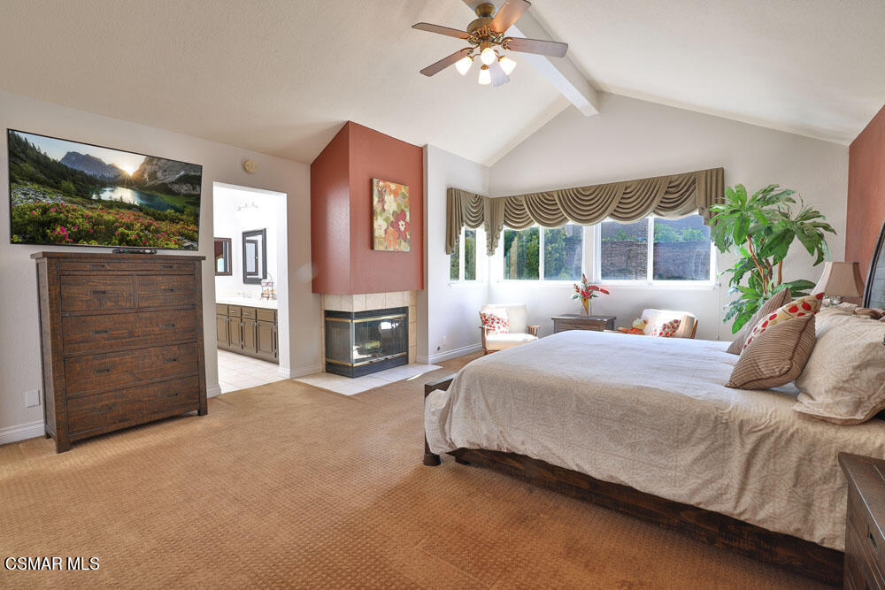 13620 Chesterfield Drive Moorpark, CA 93021 - Photo 39 of 52 a bedroom with a bed flat screen tv and a fireplace