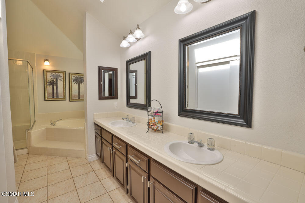 13620 Chesterfield Drive Moorpark, CA 93021 - Photo 40 of 52 a bathroom with a granite countertop sink mirror and bathtub