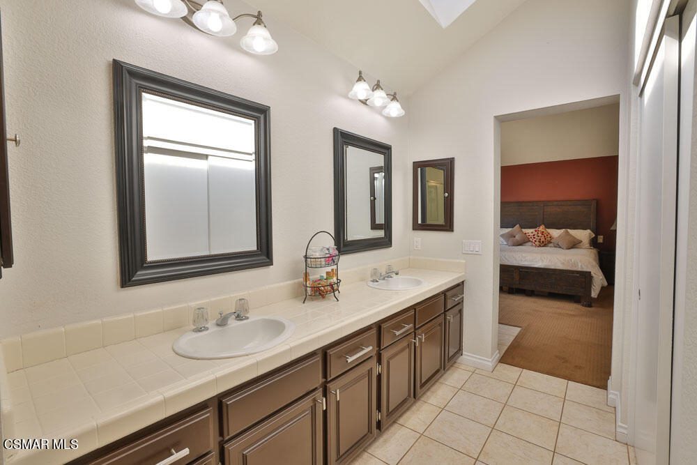 13620 Chesterfield Drive Moorpark, CA 93021 - Photo 41 of 52 a en suite bathroom with double sink and a mirror