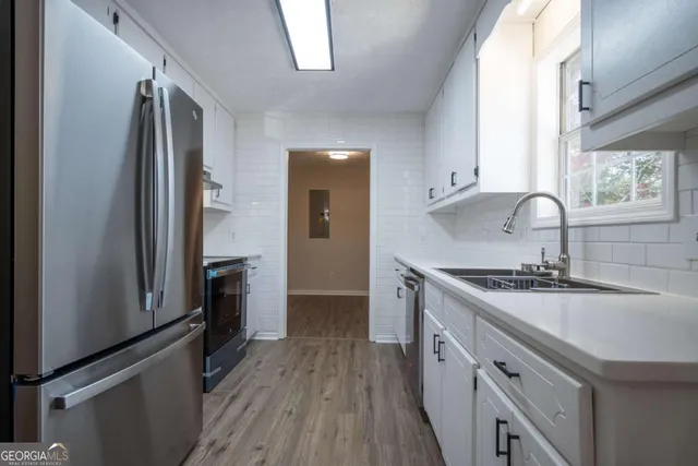 a kitchen with a sink stove and refrigerator