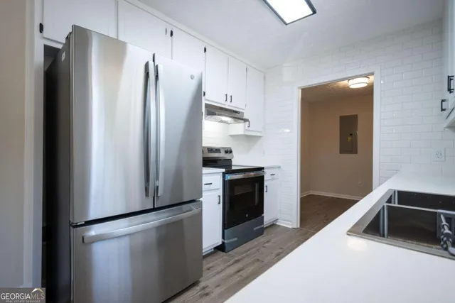 a kitchen with stainless steel appliances granite countertop a refrigerator and a sink