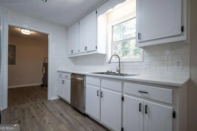 a kitchen with sink cabinets and window