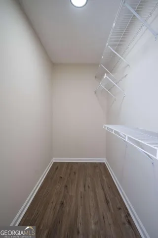 a view of a room with wooden floor