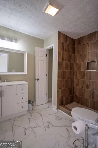 a bathroom with a sink toilet and shower