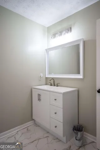 a bathroom with a sink and mirror