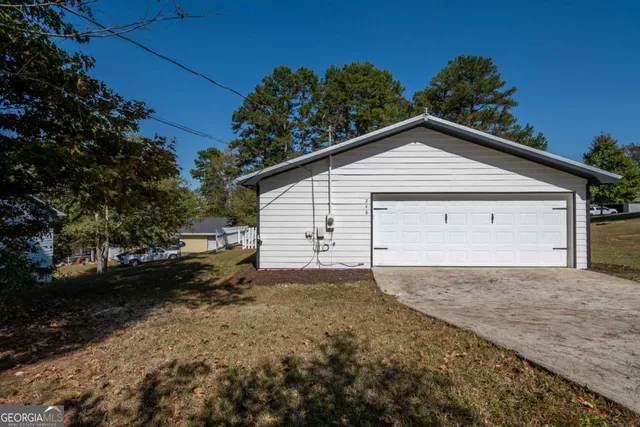 a view of a house with a yard and garage