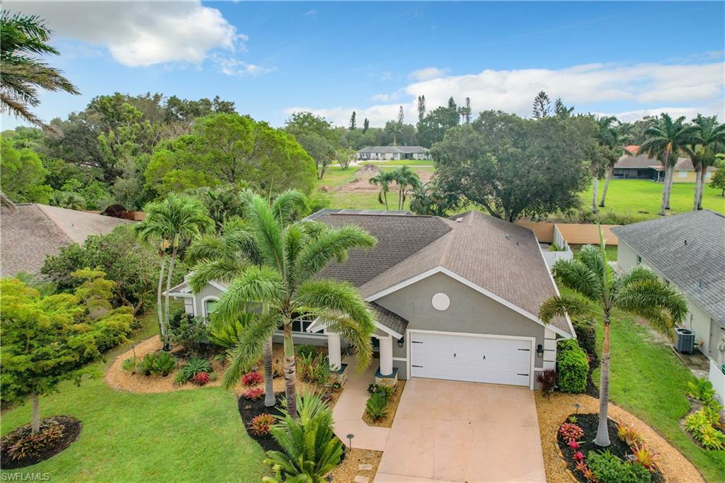 10231 Boca Circle Naples, FL 34109 - Photo 1 of 44 an aerial view of a house with a garden