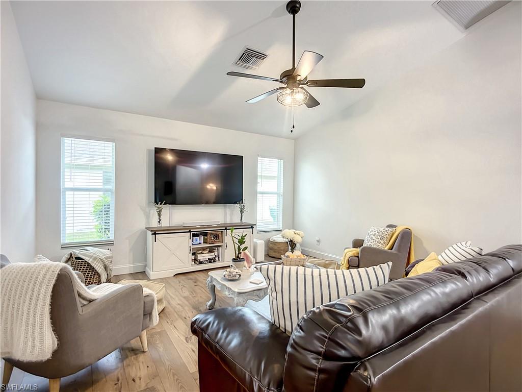 10231 Boca Circle Naples, FL 34109 - Photo 17 of 44 a living room with furniture and a flat screen tv