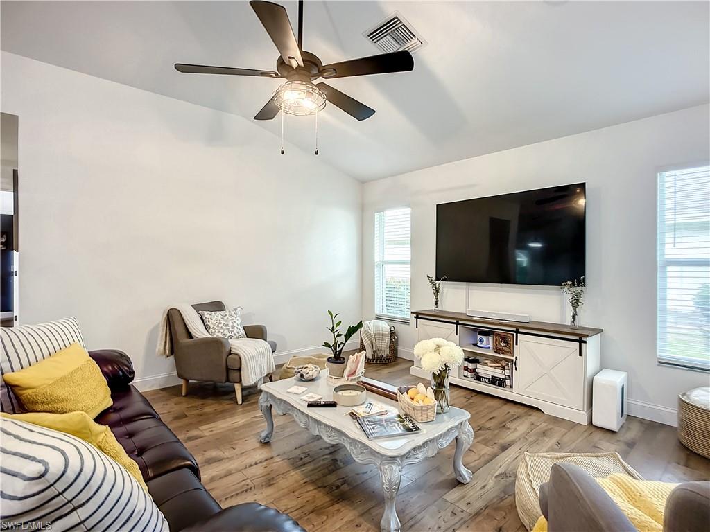 10231 Boca Circle Naples, FL 34109 - Photo 18 of 44 a living room with furniture and a flat screen tv