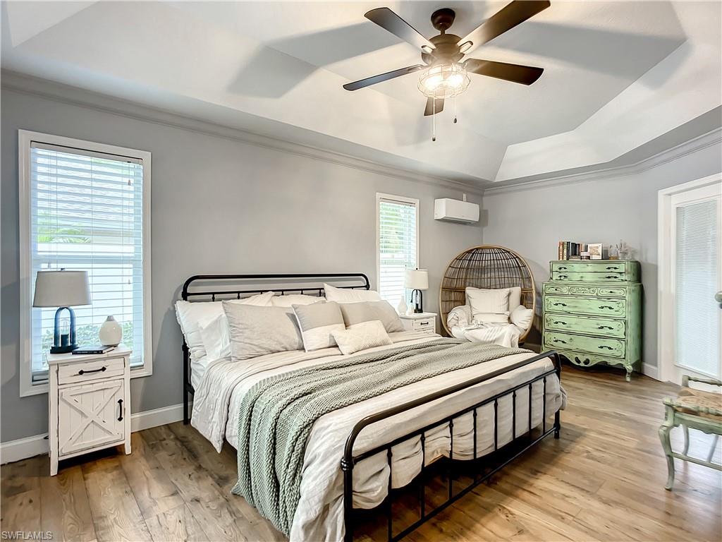 10231 Boca Circle Naples, FL 34109 - Photo 20 of 44 a bedroom with bed and a chandelier