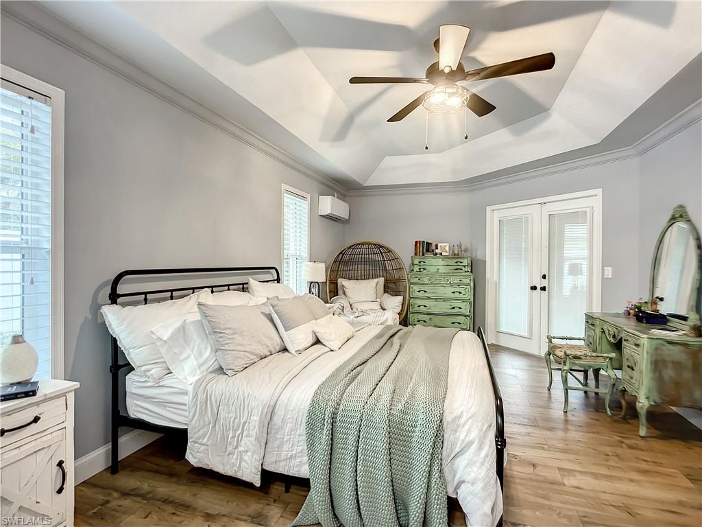 10231 Boca Circle Naples, FL 34109 - Photo 21 of 44 a bedroom with bed and wooden floor