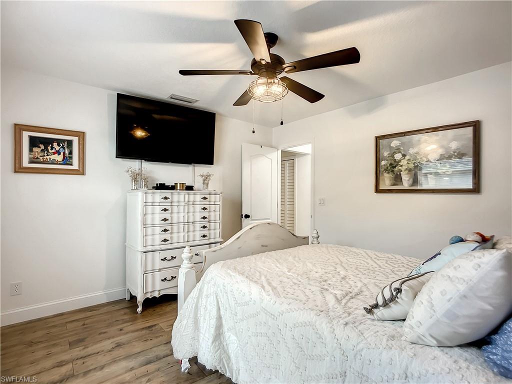 10231 Boca Circle Naples, FL 34109 - Photo 28 of 44 a bedroom with a bed and a flat screen tv