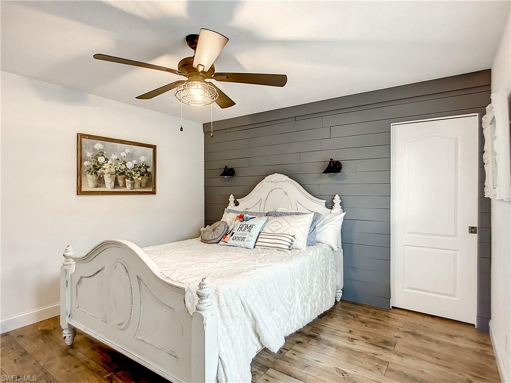 10231 Boca Circle Naples, FL 34109 - Photo 29 of 44 a bedroom with a bed and a chandelier
