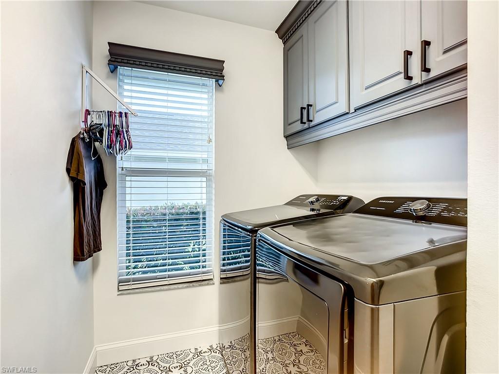 10231 Boca Circle Naples, FL 34109 - Photo 32 of 44 a kitchen with a sink a refrigerator and cabinets