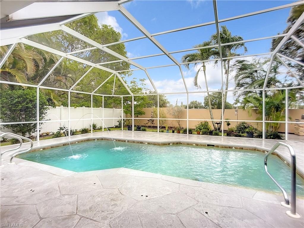 10231 Boca Circle Naples, FL 34109 - Photo 37 of 44 a view of a swimming pool with a patio and a tub