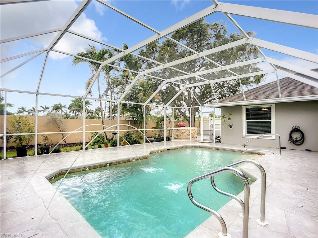 10231 Boca Circle Naples, FL 34109 - Photo 38 of 44 a view of a swimming pool with a patio