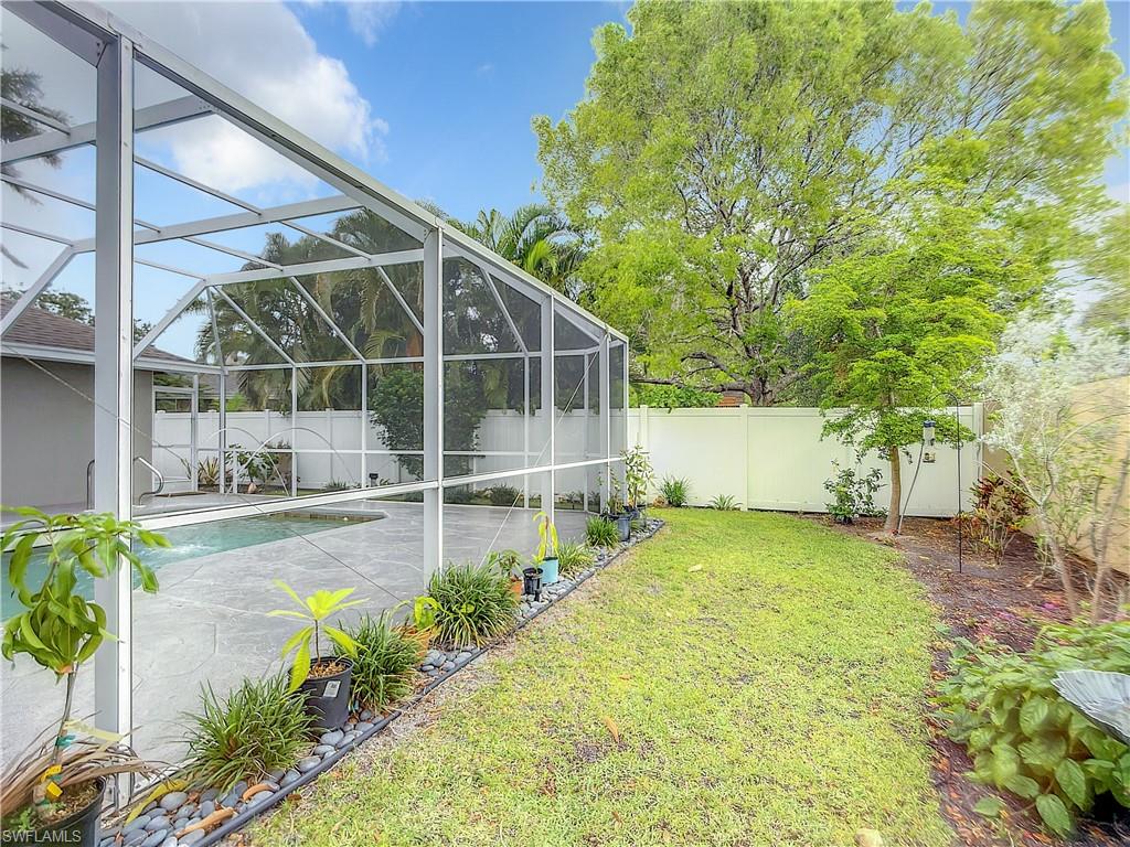 10231 Boca Circle Naples, FL 34109 - Photo 44 of 44 a view of a backyard with a garden and plants