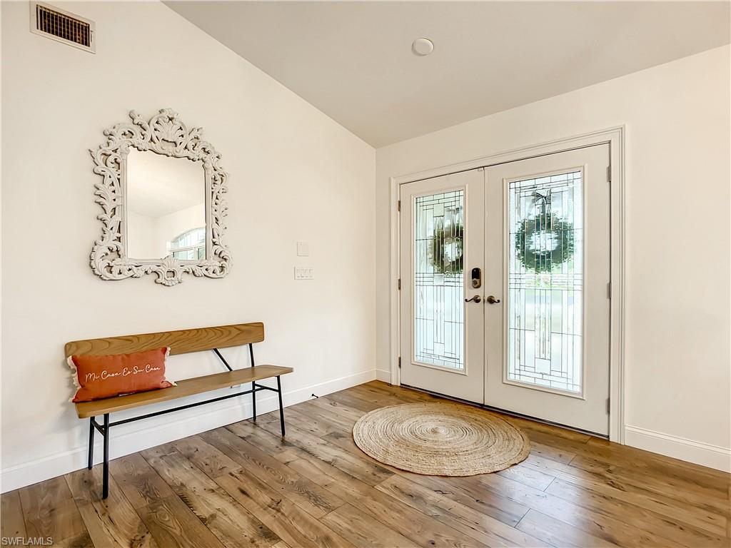 10231 Boca Circle Naples, FL 34109 - Photo 7 of 44 a view of a livingroom with furniture and a potted plant