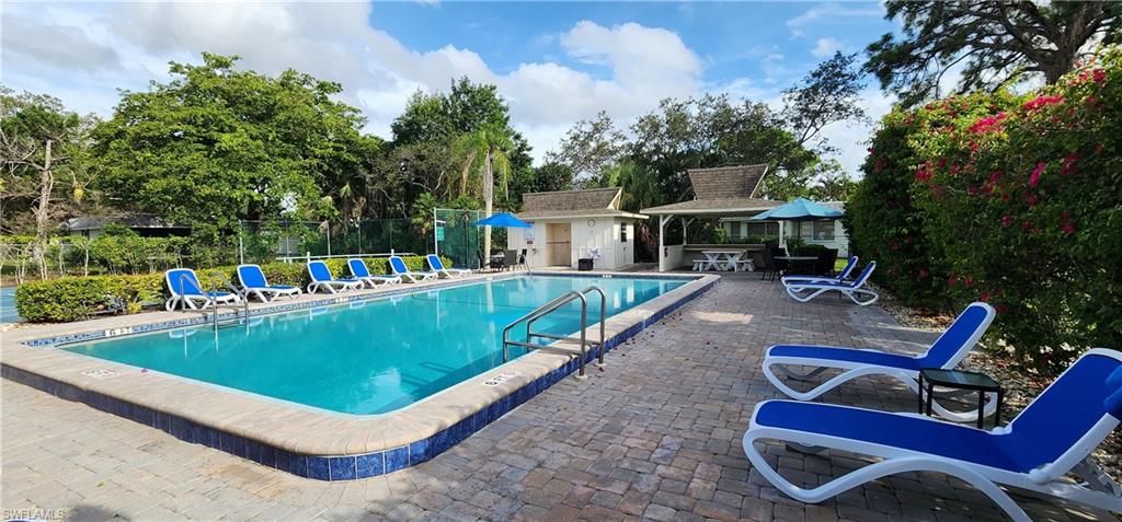 91 Georgetown Boulevard, Unit 91 Naples, FL 34112 - Photo 18 of 22 swimming pool with outdoor seating