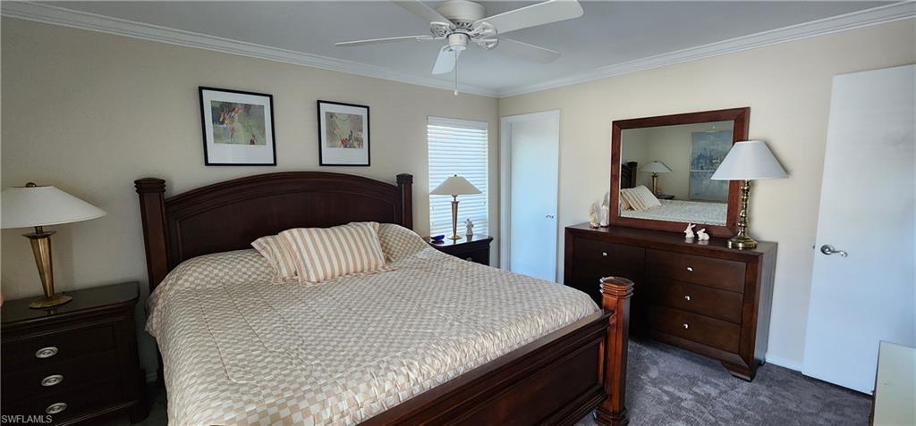 91 Georgetown Boulevard, Unit 91 Naples, FL 34112 - Photo 7 of 22 a bedroom with a bed and a dresser