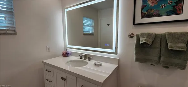 a bathroom with a sink and mirror