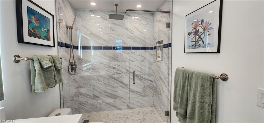 91 Georgetown Boulevard, Unit 91 Naples, FL 34112 - Photo 10 of 22 a bathroom with a shower and a toilet