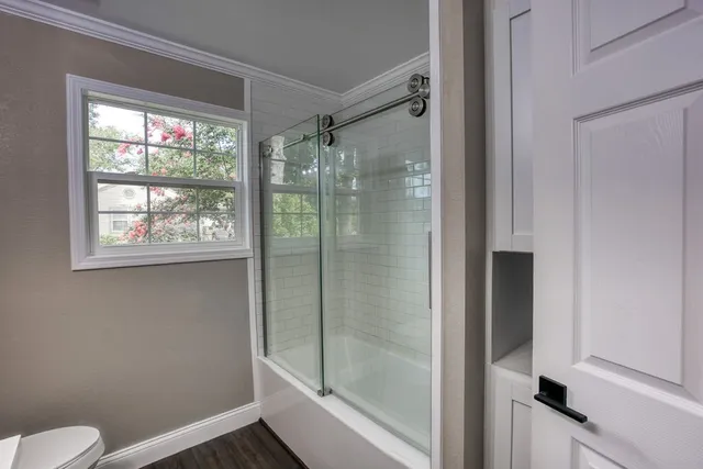 a bathroom with a shower and toilet