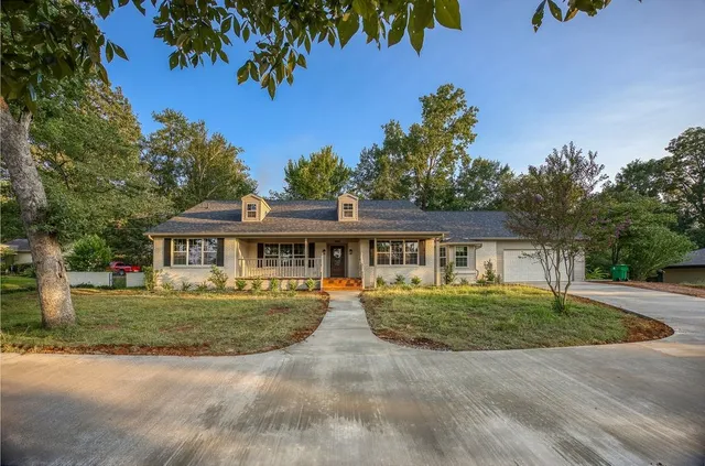 a front view of a house with a garden