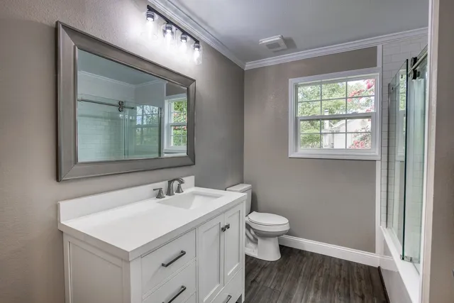 a bathroom with a sink toilet and a mirror