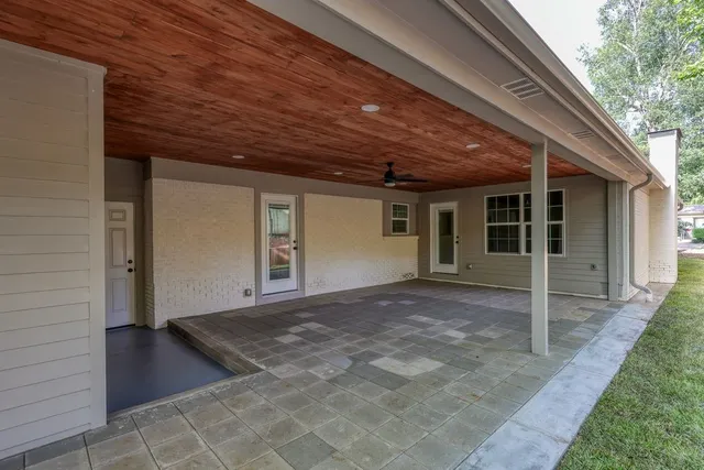 a view of hallway with large windows and wooden floor