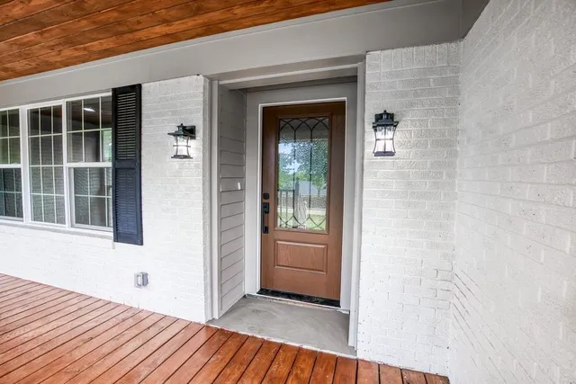 view of outdoor space with wooden floor and windows