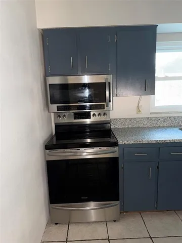a stove top oven sitting inside of a kitchen