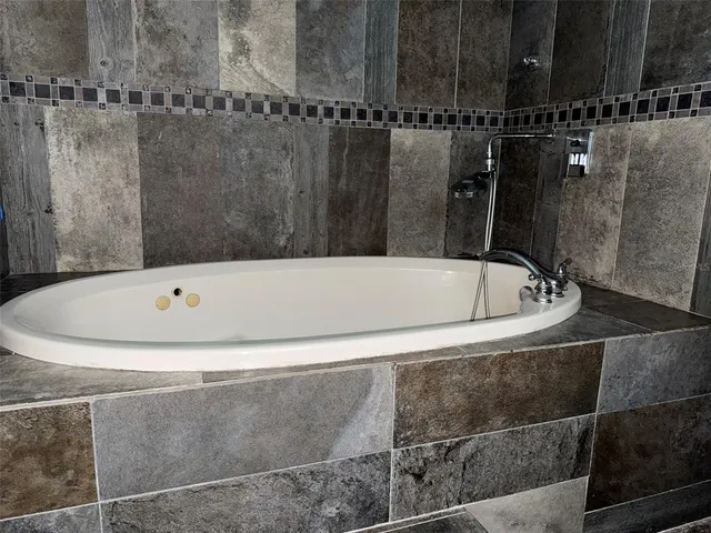 a white bath tub sitting in a bathroom