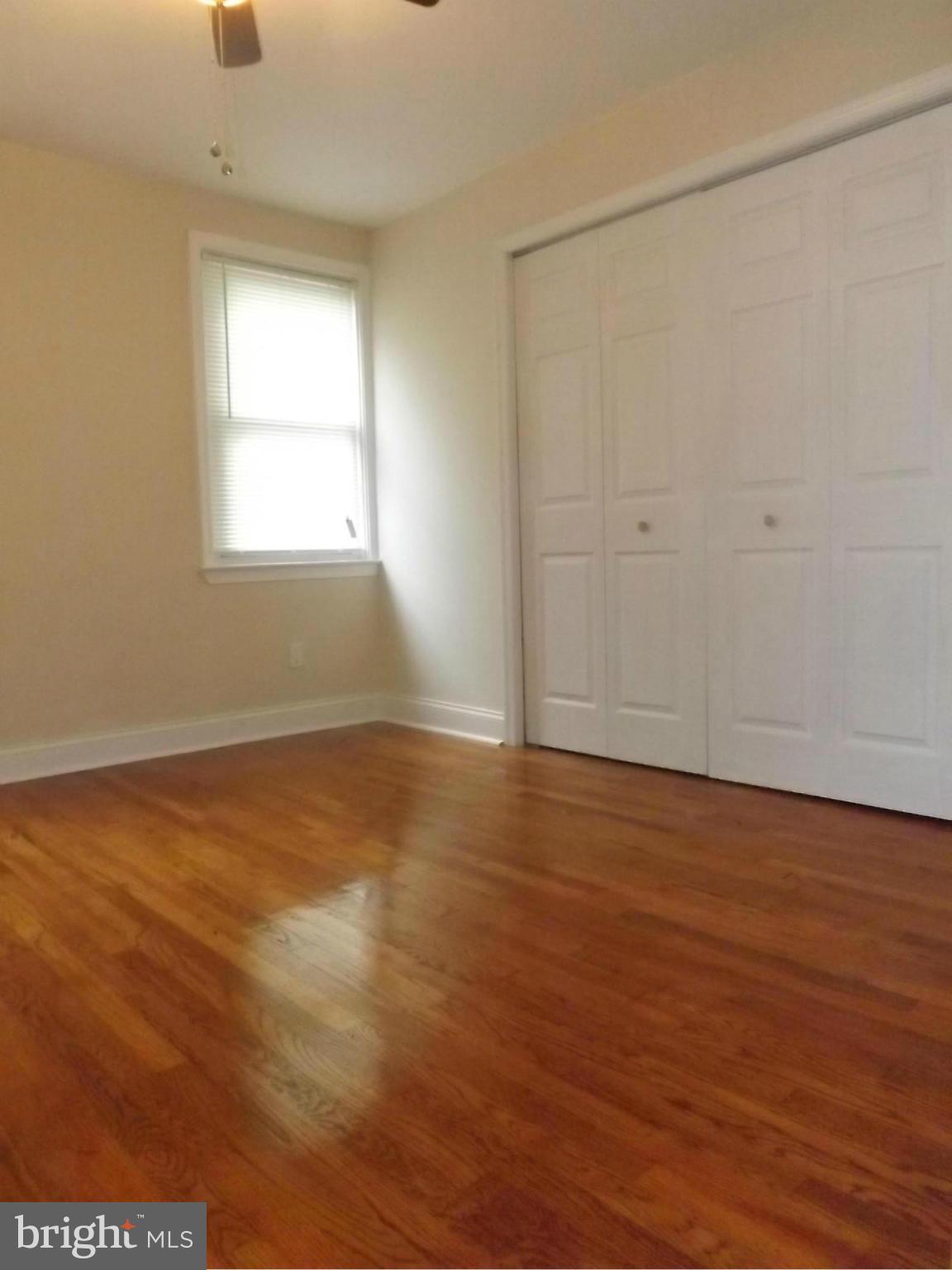 705 St Dunstans Road Baltimore, MD 21212 - Photo 12 of 21 an empty room with wooden floor and windows