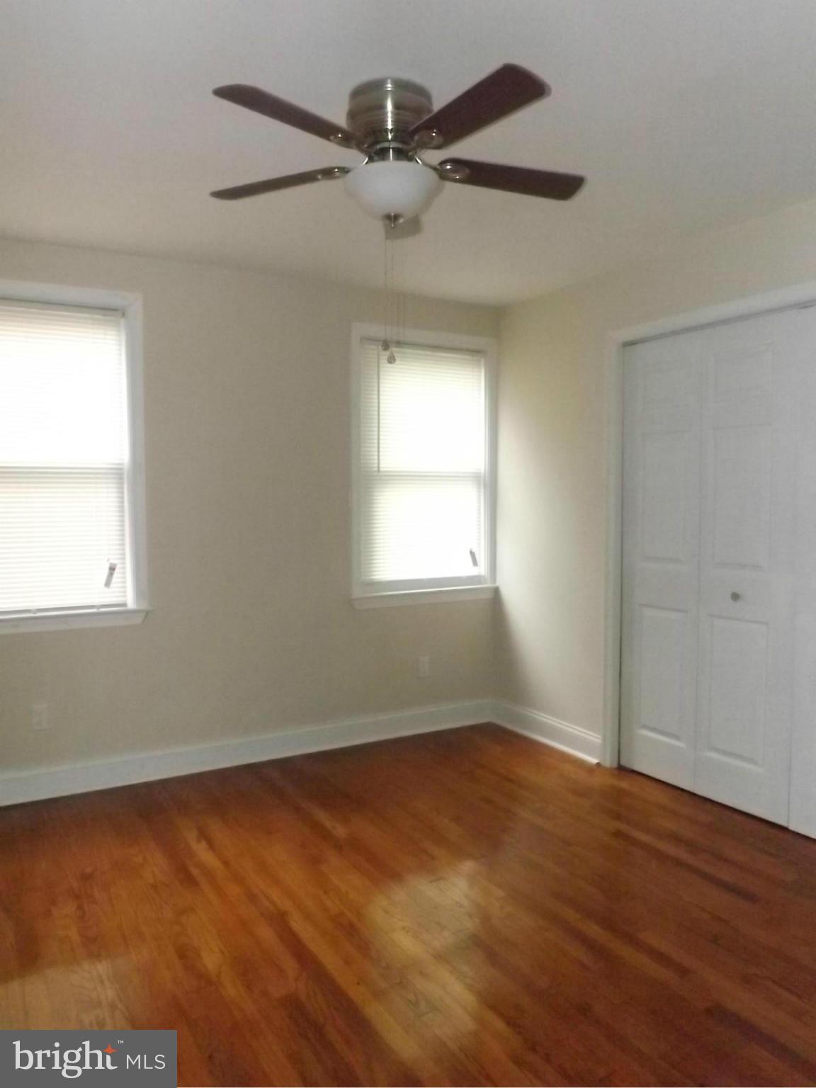 705 St Dunstans Road Baltimore, MD 21212 - Photo 13 of 21 a view of an empty room with wooden floor and a window