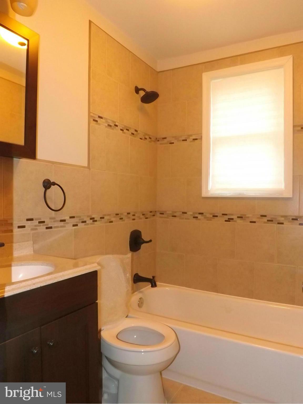 705 St Dunstans Road Baltimore, MD 21212 - Photo 15 of 21 a bathroom with a sink a toilet and a bathtub
