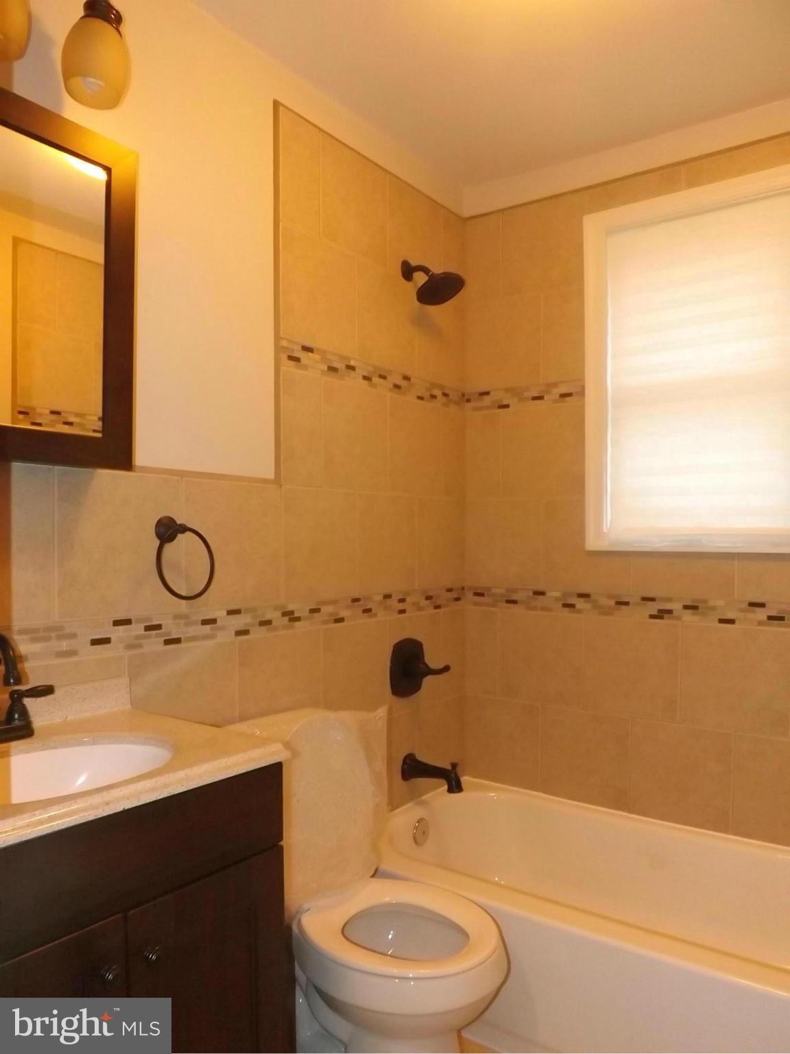 705 St Dunstans Road Baltimore, MD 21212 - Photo 16 of 21 a bathroom with a sink a toilet and shower