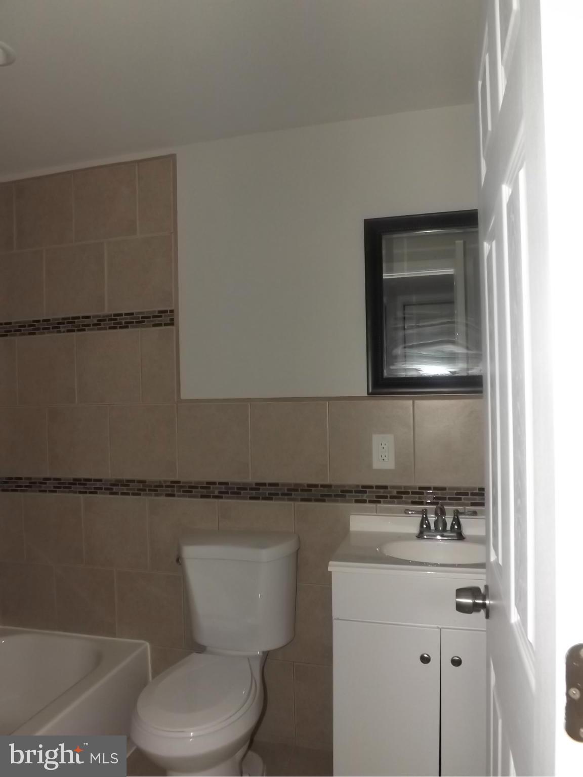 705 St Dunstans Road Baltimore, MD 21212 - Photo 18 of 21 a bathroom with a granite countertop toilet sink and mirror